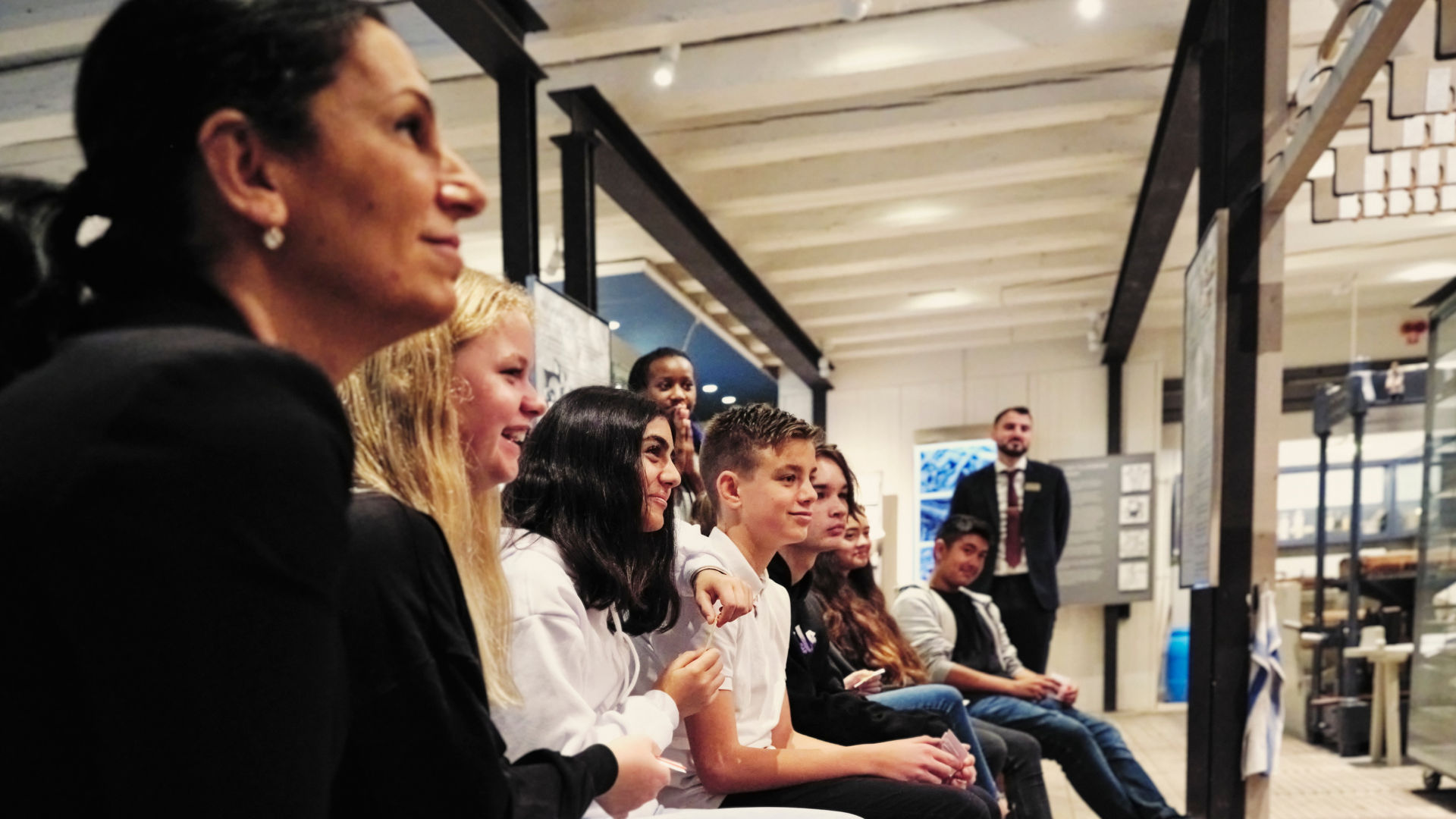 Students listening to a guide in the museum. 