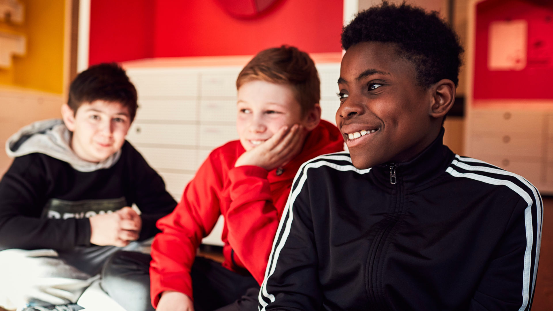 Youths sitting arouind a table.