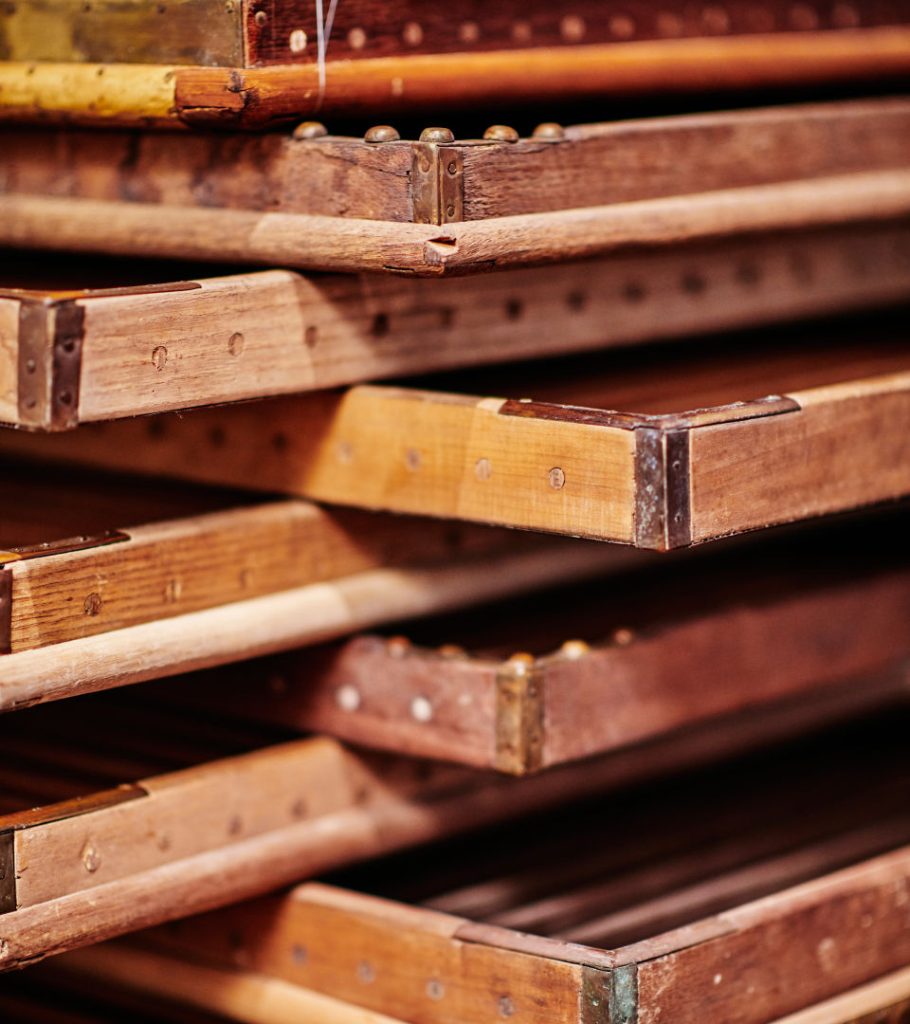 Wooden frames and a stack of paper. 