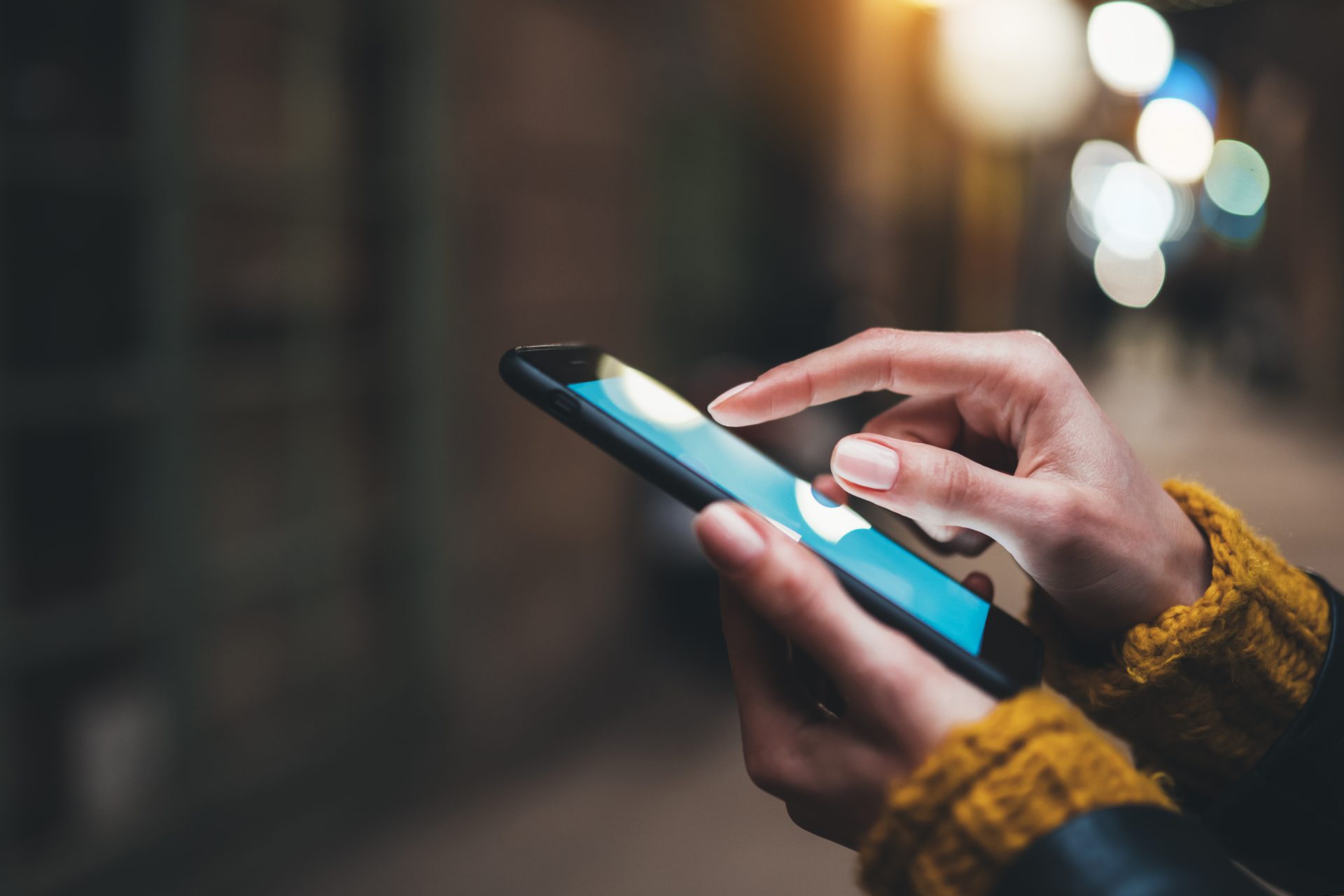 Person holding a smartphone in the dark