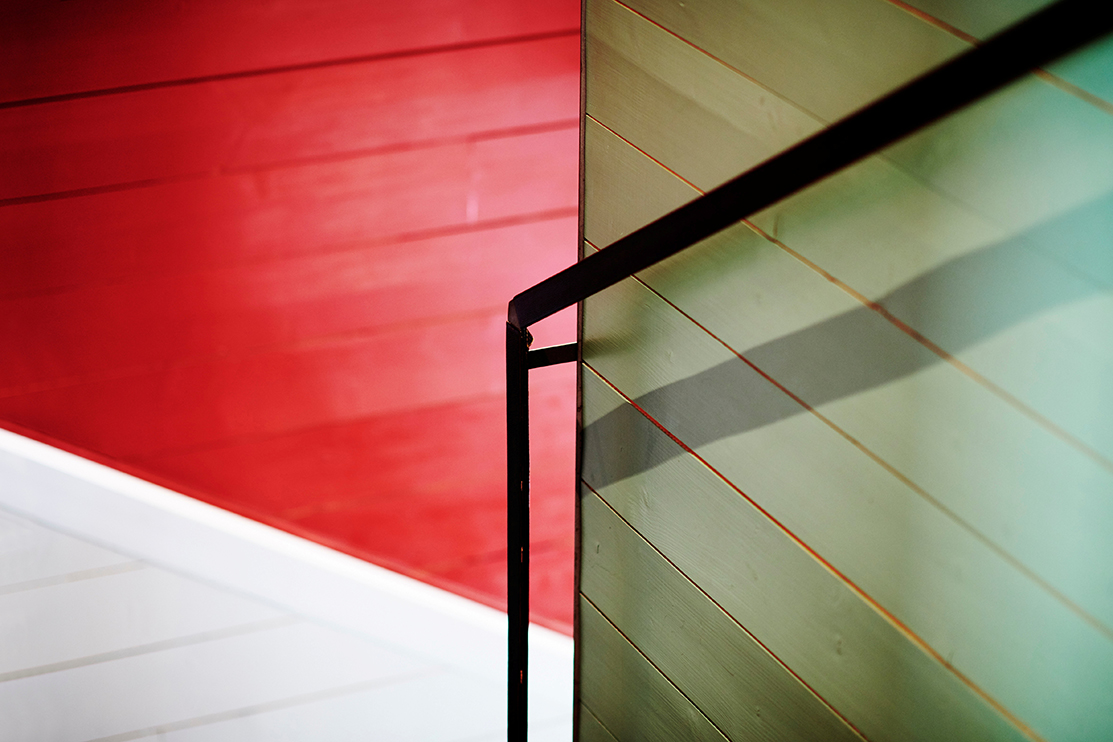 A detailed image of a stairwell in green, red and white.