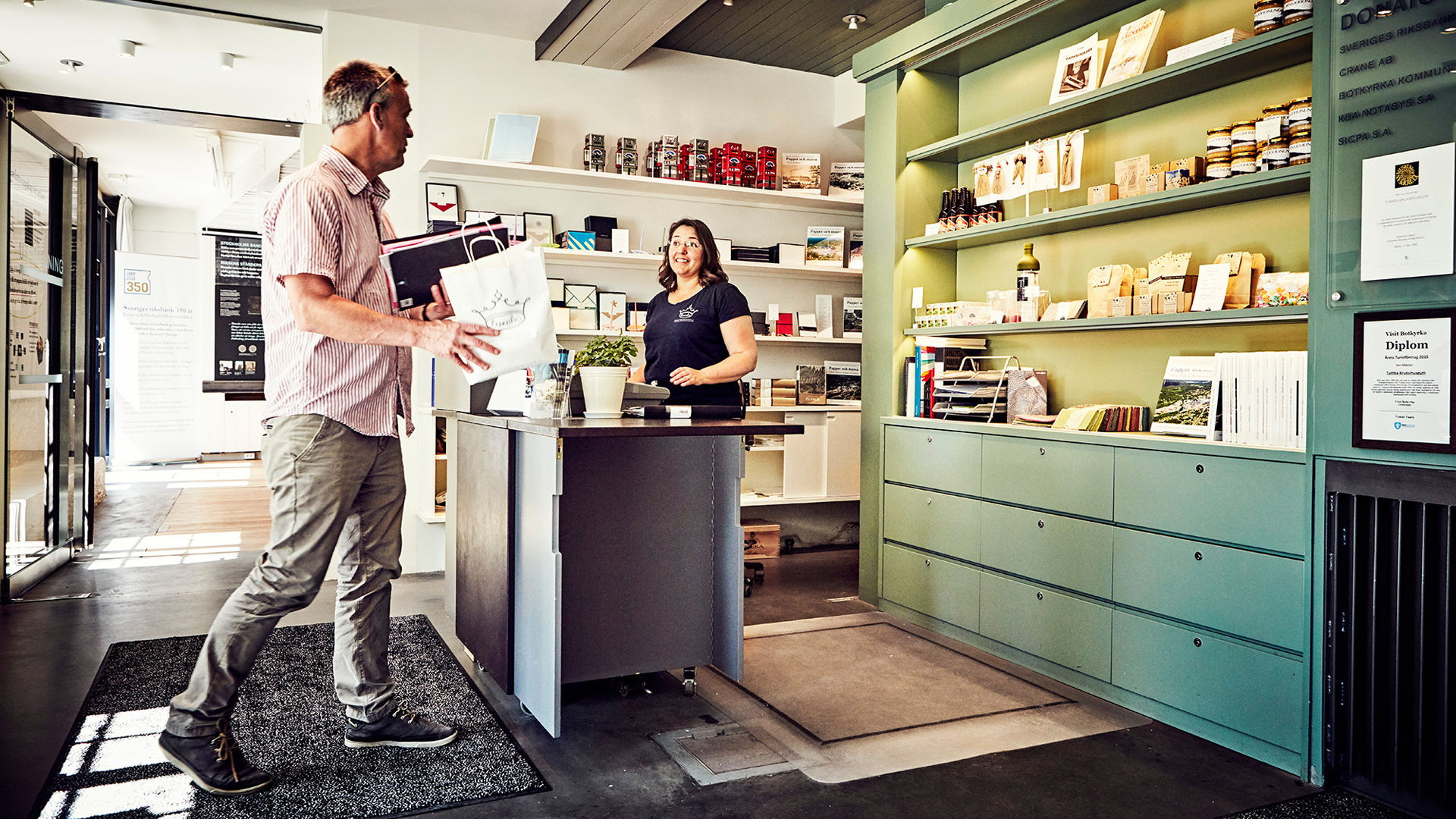 The museum shop with visitors and staff.