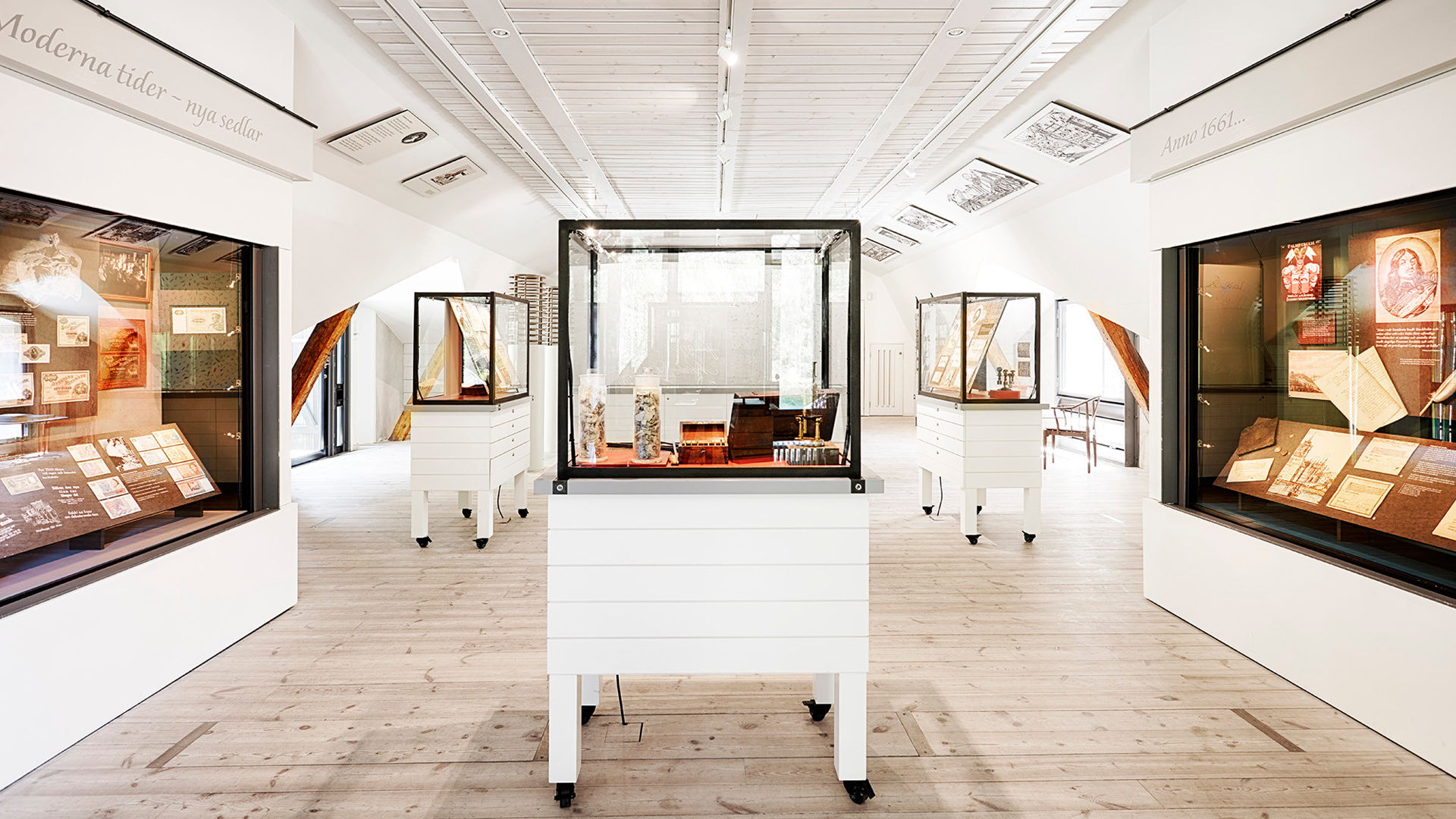 Display cases in a white exhibition room.