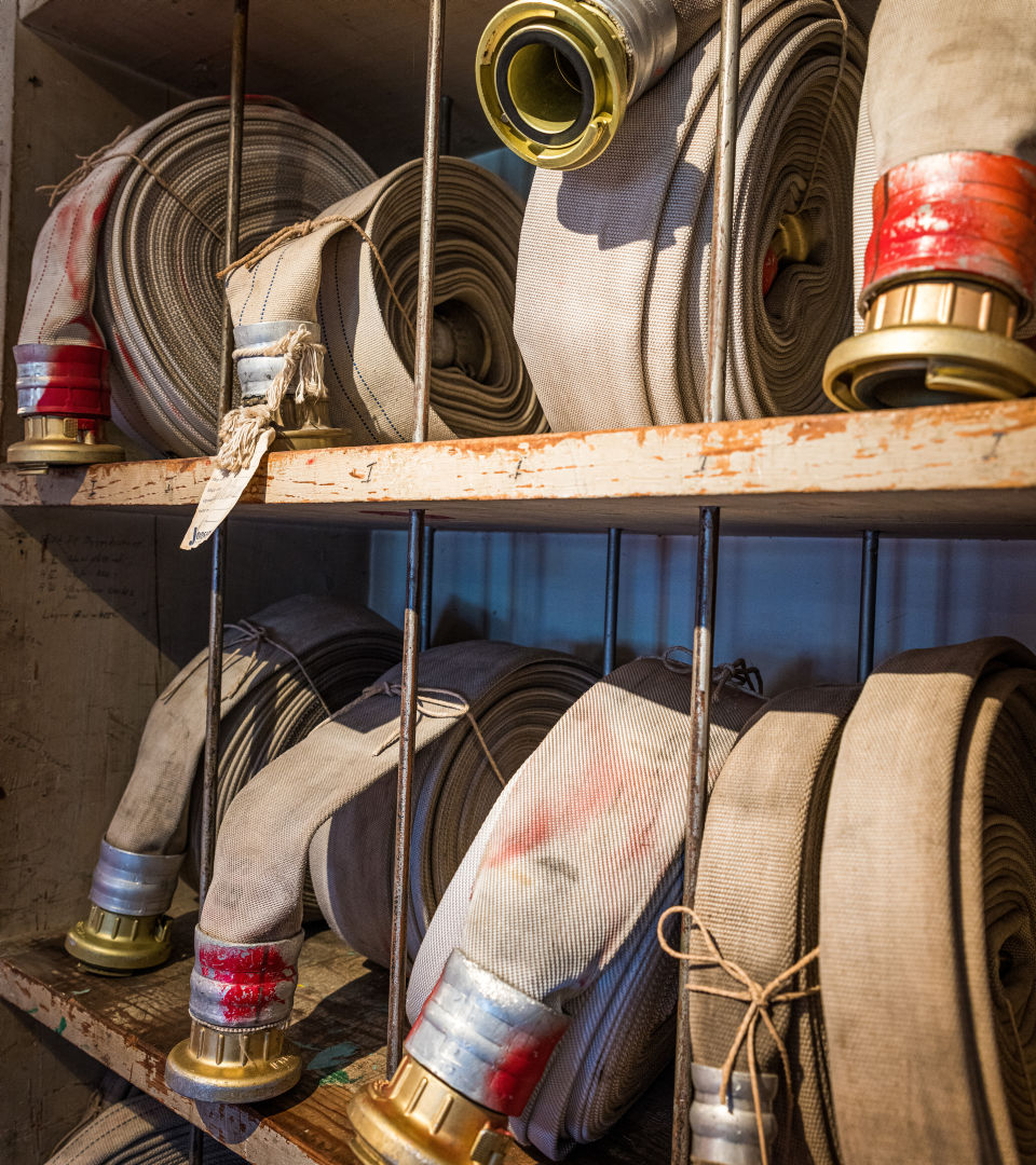 Fire hoses placed on shelves. 