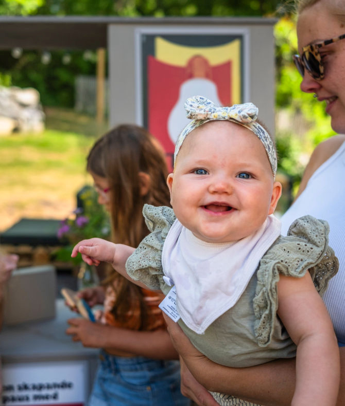 Baby smiling in parent's arms