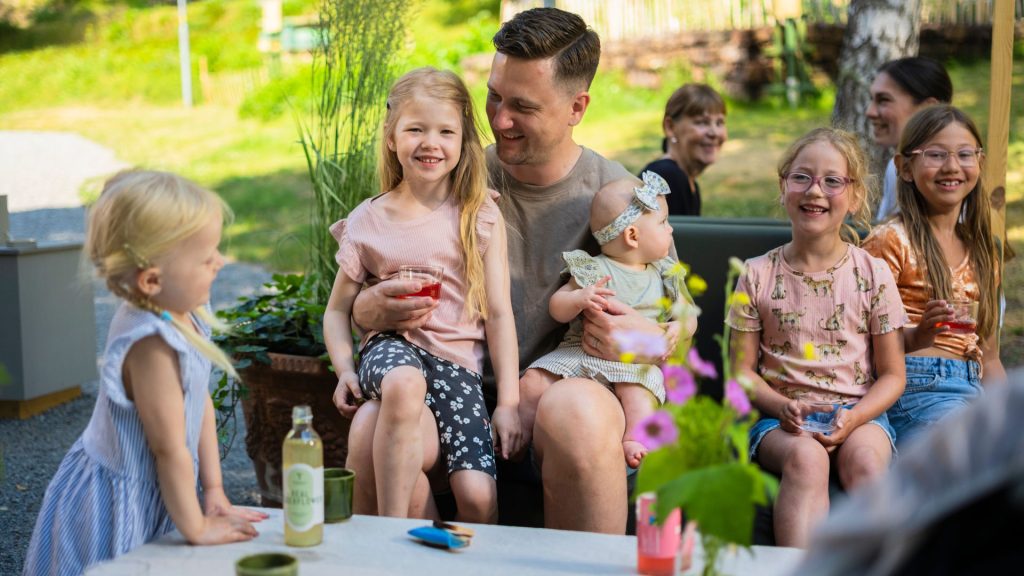 Children and parent having a snack outdoors